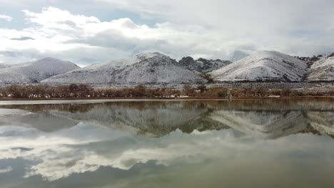 Landscape-of-Lake-Diaz-and-snow-covered-hills-in-winter-with-grass-in-foreground