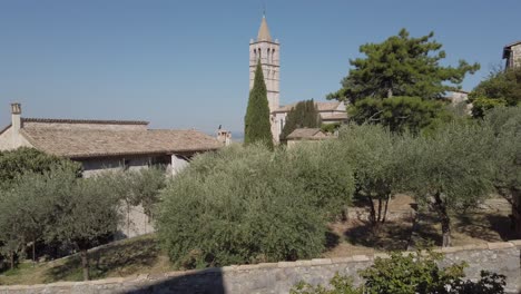 View-on-the-bell-tower-of-Basilica-of-Saint-Clare-in-Assisi-with-lush-foreground