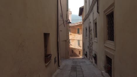 Walking-in-a-narrow-medieval-street-of-TREVI,-an-Umbrian-town-in-central-Italy