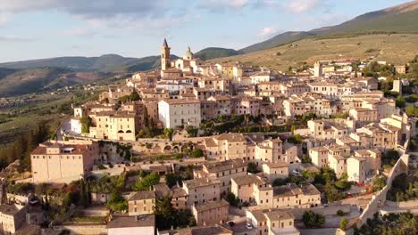 Aerial-view-of-Trevi,-a-charming-medieval-town-with-Monte-Serano-in-the-background