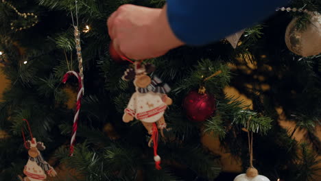 Hanging-a-reindeer-decoration-on-a-Christmas-tree