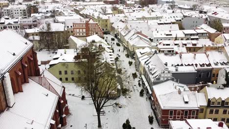 Cinematic-view-of-Kaunas-old-town-covered-in-snow,-drone