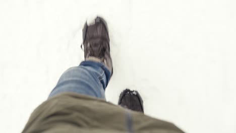 Anonymous-Person-Wearing-Jacket-And-Winter-Shoes-Walking-Carefully-In-Snow