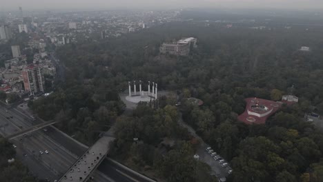 Aerial-Flying-Towards-Castle-of-Chapultepec-Past-Altar-a-la-Patria-On-Misty-Day-In-Mexico-City