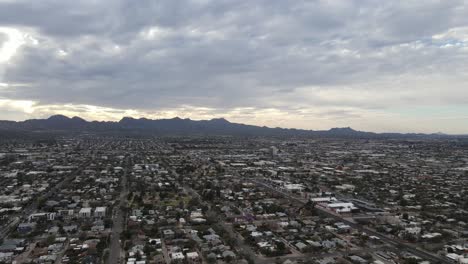 Drone-panning-slowly-over-Tucson,-Arizona,-United-States-on-a-cloudy-day
