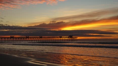 Time-lapse-video-of-golden-sunrise-looking-onto-a-pier