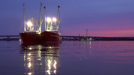 Two-Shrimp-Trawlers,-commercial-fishing-boats-docked-in-New-Bern-during-a-protest-against-regulations,-at-dusk,-in-North-Carolina