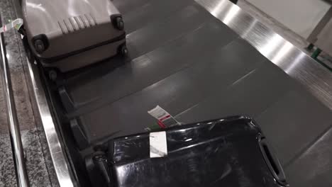 Various-luggage-baggage-with-tags-moving-circle-on-a-luggage-carousel-for-passengers-arriving-in-Europe-for-holiday