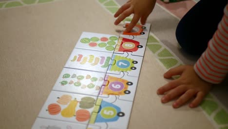 Child-Playing-With-Colorful-Puzzles-With-Numbers-Learning-to-Count