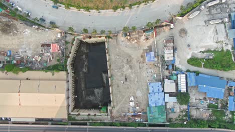 Top-down-view-of-huge-deep-hole-in-the-ground-at-the-construction-area