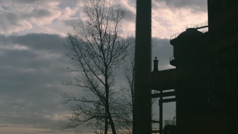Moody-timelapse-of-factory-blast-furnace-silhouetted-by-evening-clouds