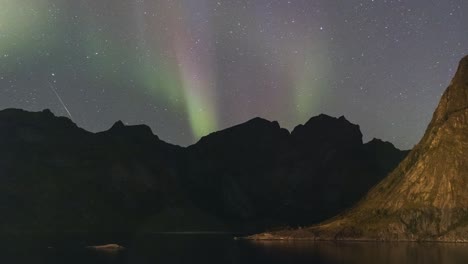 Time-lapse-of-polar-lights-with-mountains-in-front-near-Tromso,-Norway