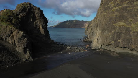Passage-on-Whatipu-beach-surrounded-by-cliff-formations-towards-Manukau-Heads