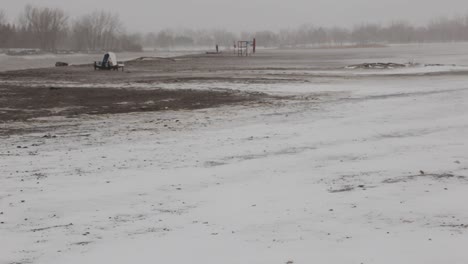 Snowflakes-Falling-Covering-the-Field-With-Snow-During-Winter-Season---Medium-Shot