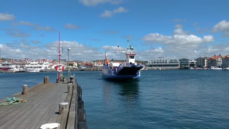Ferry-is-pulling-into-the-wharf-to-dock-in-Marstrand,-West-coast-of-Sweden