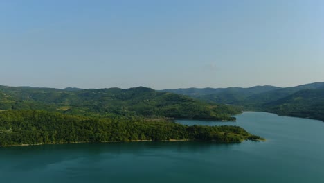Lake-Butoniga-water-reservoir-dam-in-Croatia-pan-left-panorama,-Aerial-drone-left-reveal-shot