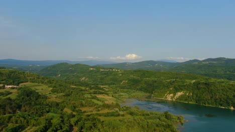 Lake-Butoniga-water-dam-in-Croatia-left-pan-revealing-nearby-hills,-Aerial-drone-left-pan-reveal-shot