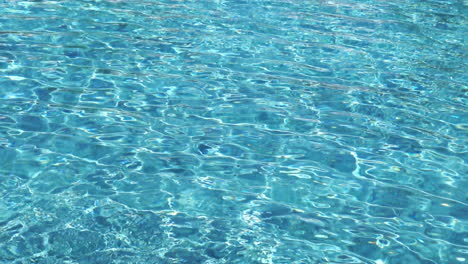 Crystal-clear-swimming-pool-water,-with-the-light-reflecting-off-the-surface