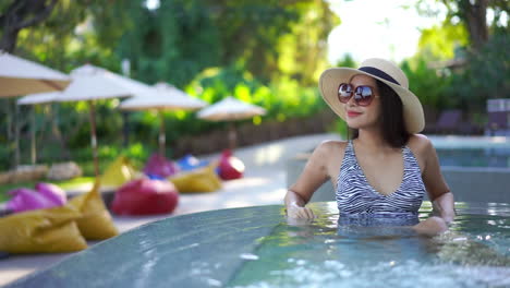 Elegant-adult-woman-on-holiday-sitting-in-hot-tub-whirlpool