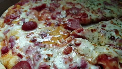 Pizza-perfect,-extra-melting-cheddar-cheese,-extra-salami-and-pepperoni-toppings-served-hot,sliced-with-a-stainless-steel-serrated-knife
