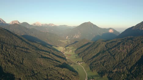 Zell-Pfarre-mountain-village---valley-aerial-dolly-right-overlooking-Slovenia-border-green-alps-Austrian-landscape