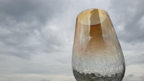 Beautiful-heat-cracked-empty-glass-flower-vase-with-stunning-rainy-day-cloud-time-lapse-background-and-water-drops-falling