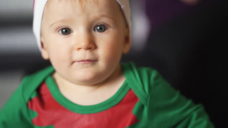 Adorable-baby-boy-with-big-bright-eyes-in-cute-elf-costume-for-Christmas