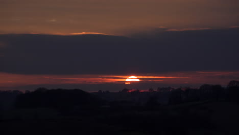 Time-lapse-of-a-beautiful-winter-sunset-over-hillside-farmland-at-Nether-Heage-in-Derbyshire