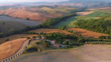 Aerial-wide-shot-surroundings-of-San-Quirico-di-Orcia-and-Val-d'Orcia-in-Tuscany-Italy