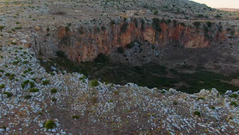 Crater-depression-in-Custonaci-Sicily-Italy-near-the-town-of-San-Vito-Lo-Capo,-Aerial-drone-dolly-out