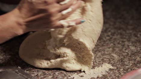 woman-kneading-dough-with-her-own-hands-in-a-marble-countertop