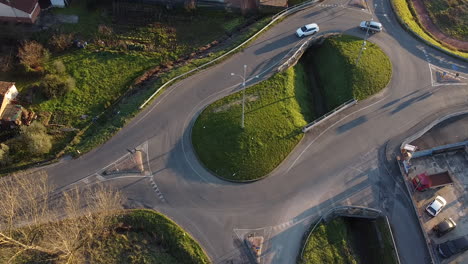 Aerial-View-of-Cars-circling-around-the-double-roundabout-with-water-canal-in-the-middle