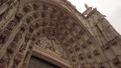 Tilt-Up,-Seville-Cathedral-Main-Door-of-Assumption-in-Spain,-Low-to-High-Pan