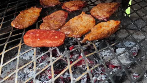Barbecue-bbq-steel-Grill-tenderized-beef-steak-pieces-over-white-hot-coals-slowly-frying-the-meat-to-perfection