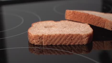 Bread-slices-against-black-background-falling-in-slow-motion