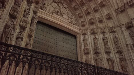 Seville-Cathedral-Main-Door-of-Assumption-in-Spain,-Tilt-Down-High-to-Low-Pan