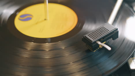 Close-up-pan-across-a-lp-record-spinning-slowly-on-a-retro-style-turntable