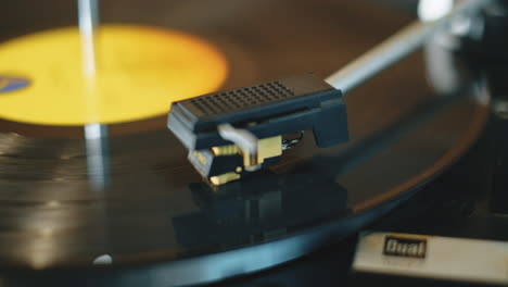 Slow-camera-slide-across-a-lp-record-spinning-on-a-vintage-turntable