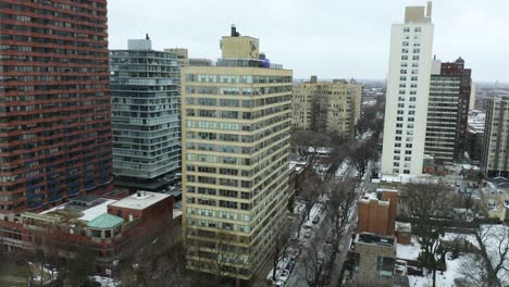 Orbiting-Aerial-Shot-of-Apartment-Building-on-Cold-Winter-Day