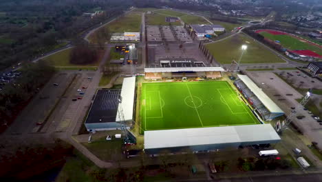 Aerial-orbit-of-active-soccer-stadium-with-large-flood-lights