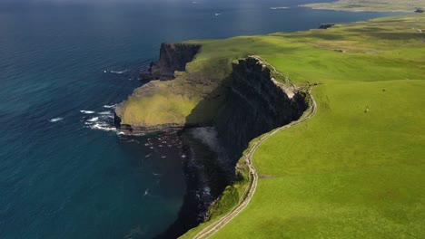 Cliffs-of-Moher-walking-trail-on-beautiful-day,-Ireland,-aerial-panorama