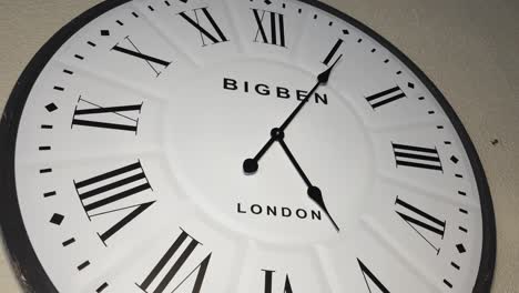 Time-lapse-of-huge-white-wooden-wall-clock-with-london-and-big-ben-written-on-it,-minutes-quickly-move-past-5pm-in-the-afternoon