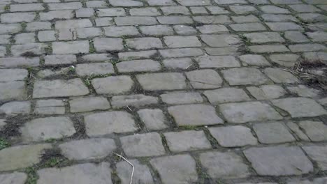 Old-urban-cobblestone-pebble-pavement-stone-surface,-Vintage-cobble-floor-street-paving