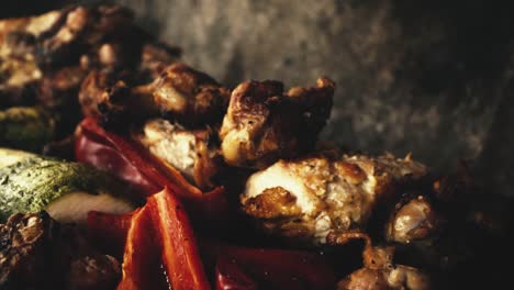Slow-motion-close-up-chicken-wings-and-grilled-vegetables,-