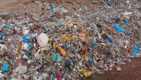 Aerial-pan-over-massive-pile-of-garbage-waste-in-a-landfill