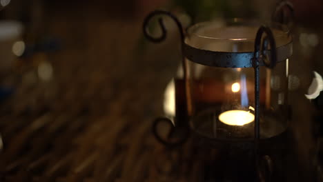 Rack-focus-of-a-romantic-warm-candlelight-flickering-on-the-table