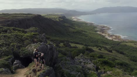 Group-Of-Hikers-Looking-At-The-Kenting-National-Park-View-On-A-Sunny-Day-In-Taiwan---Aerial-Shot