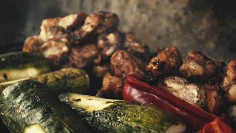 Slow-motion-close-up-chicken-wings-and-grilled-vegetables,-