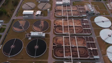 Aerial-pan-down-over-a-large-wastewater-treatment-facility