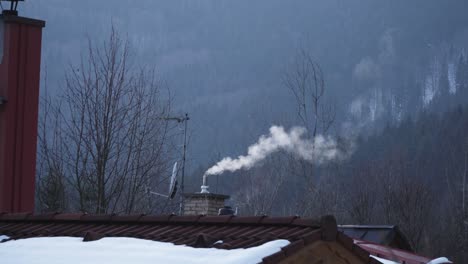 Smoke-coming-out-of-chimney-from-the-house-on-mountains-outdoor-view